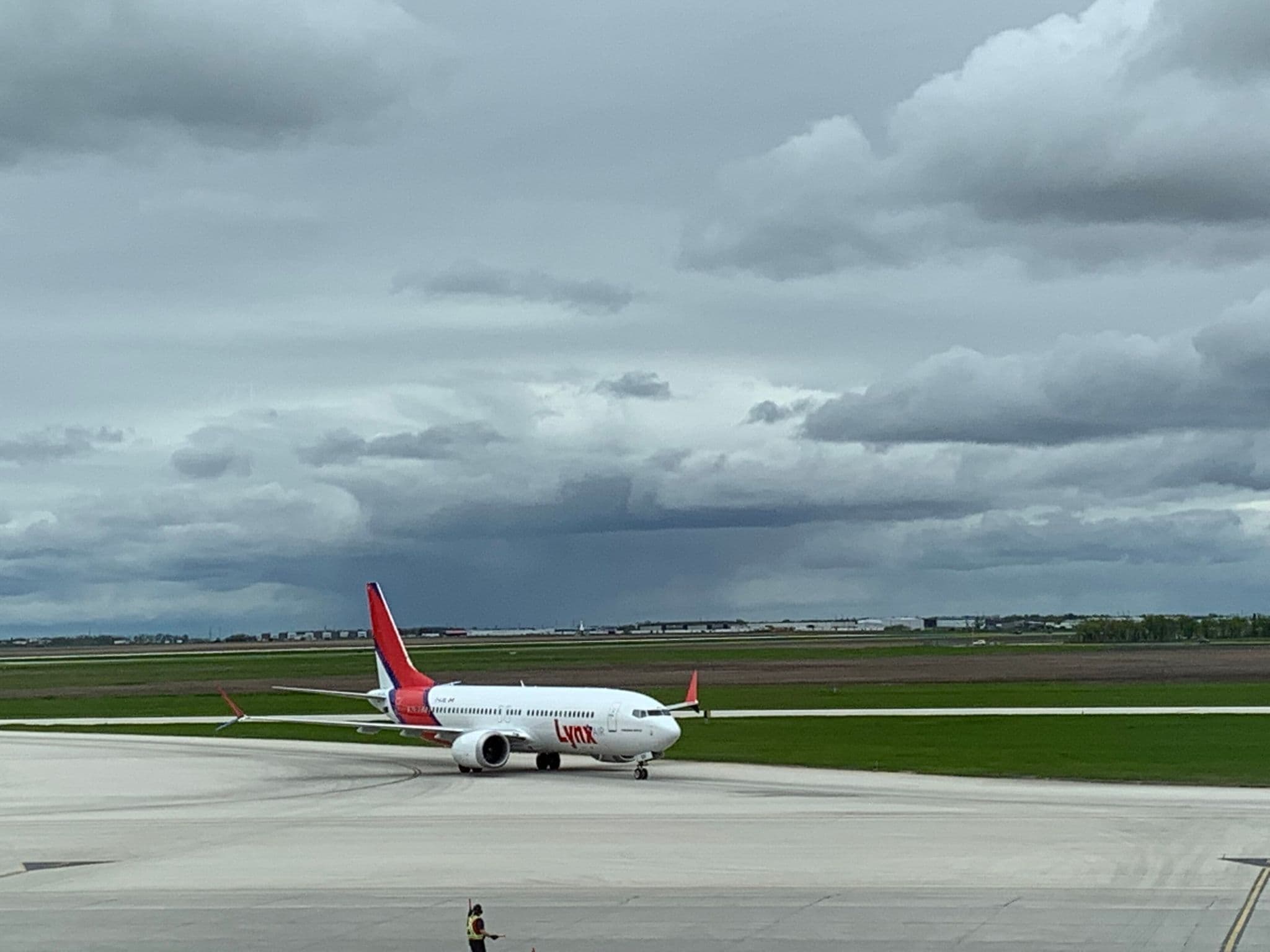 Lynx Air Boeing 737 MAX 8 taxiing to the gate at Winnipeg under a cloudy sky