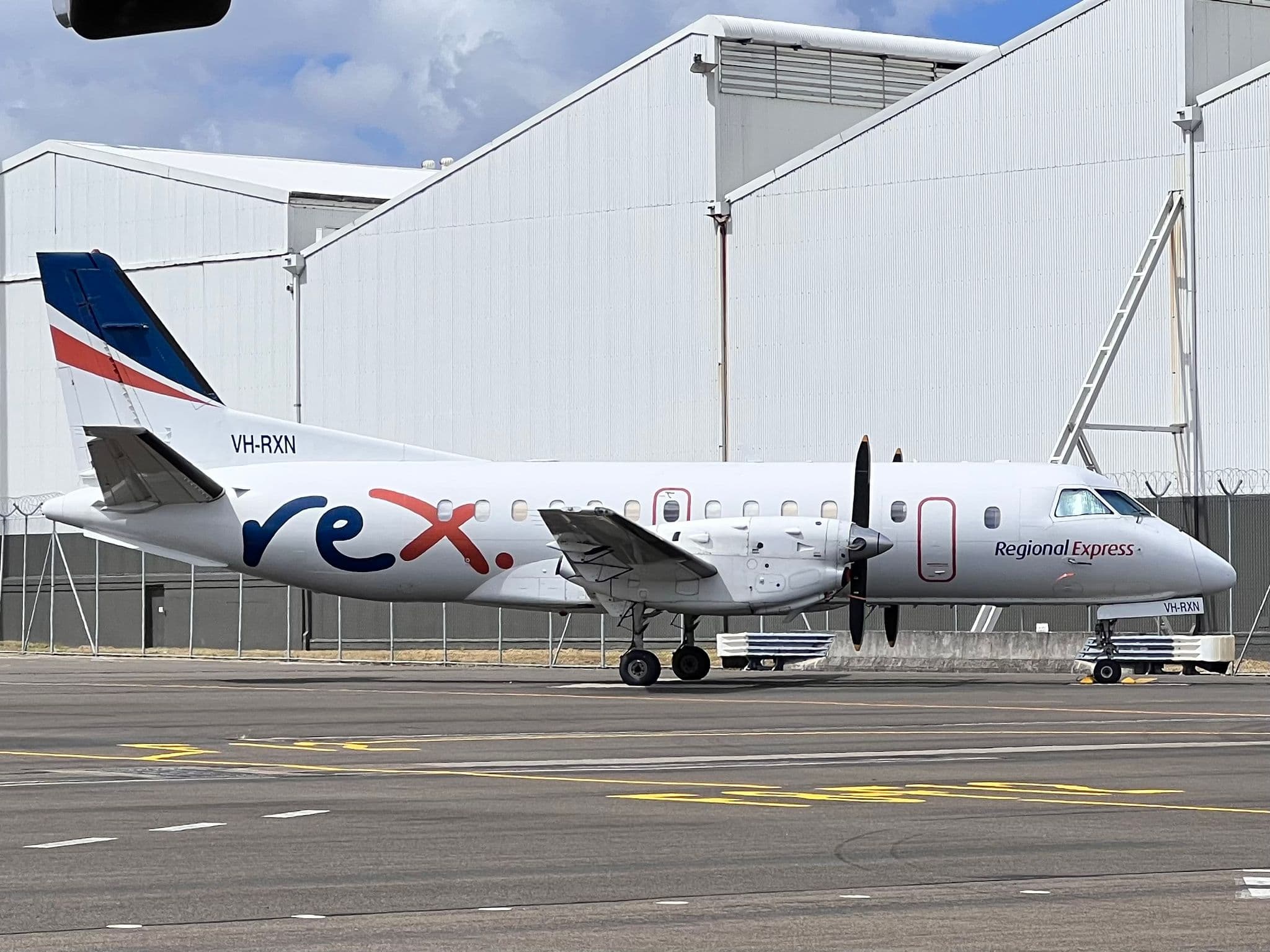 Rex Airlines Saab 340 parked at the gate at Sydney Airport Terminal 2