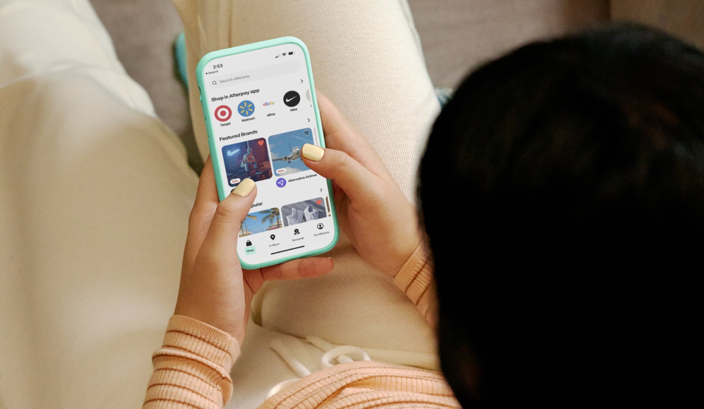 Shopper holding a phone showing the Afterpay app