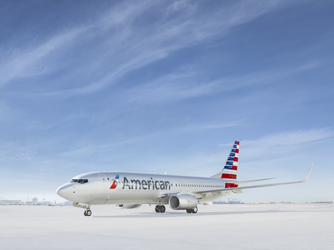 American Airlines Boeing 737 in silver livery under a blue sky