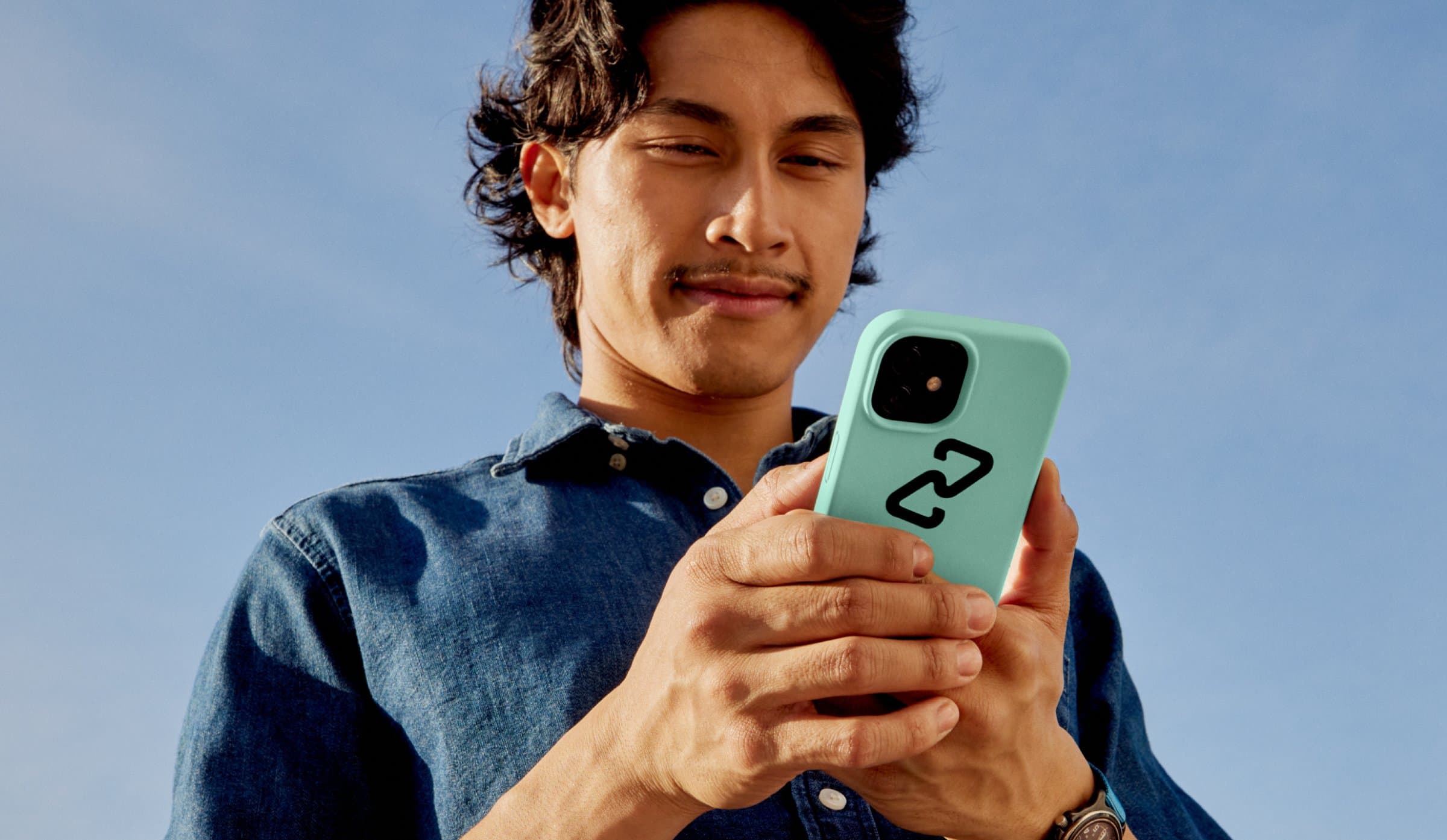 Shopper using a phone in a mint case with the Clearpay logo mark