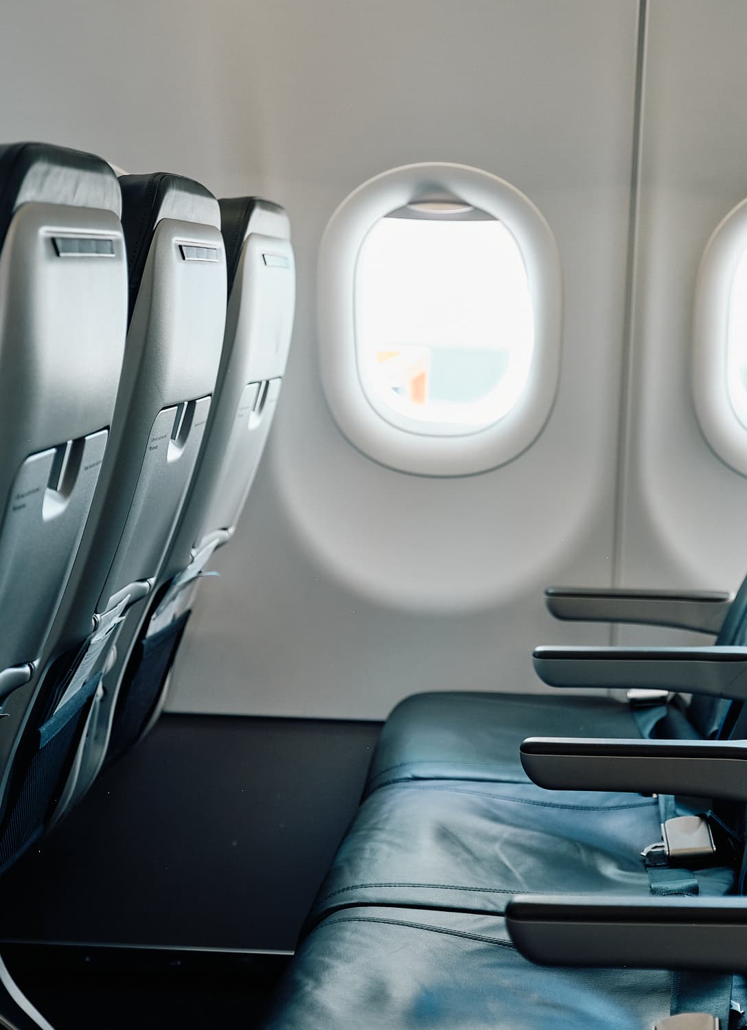 Frontier Airlines cabin seats by the window