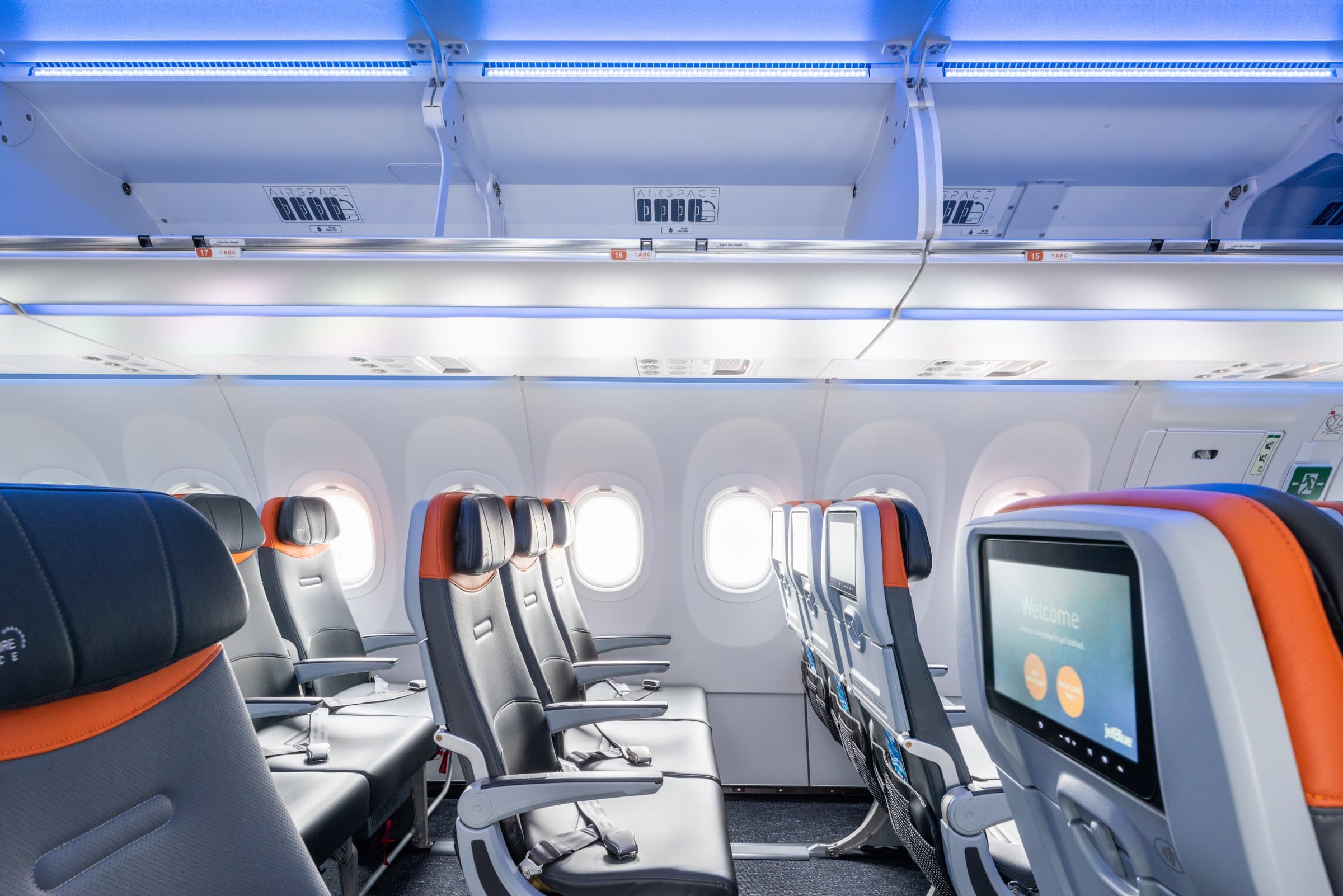 JetBlue Core cabin with blue leather seats and seatback screens