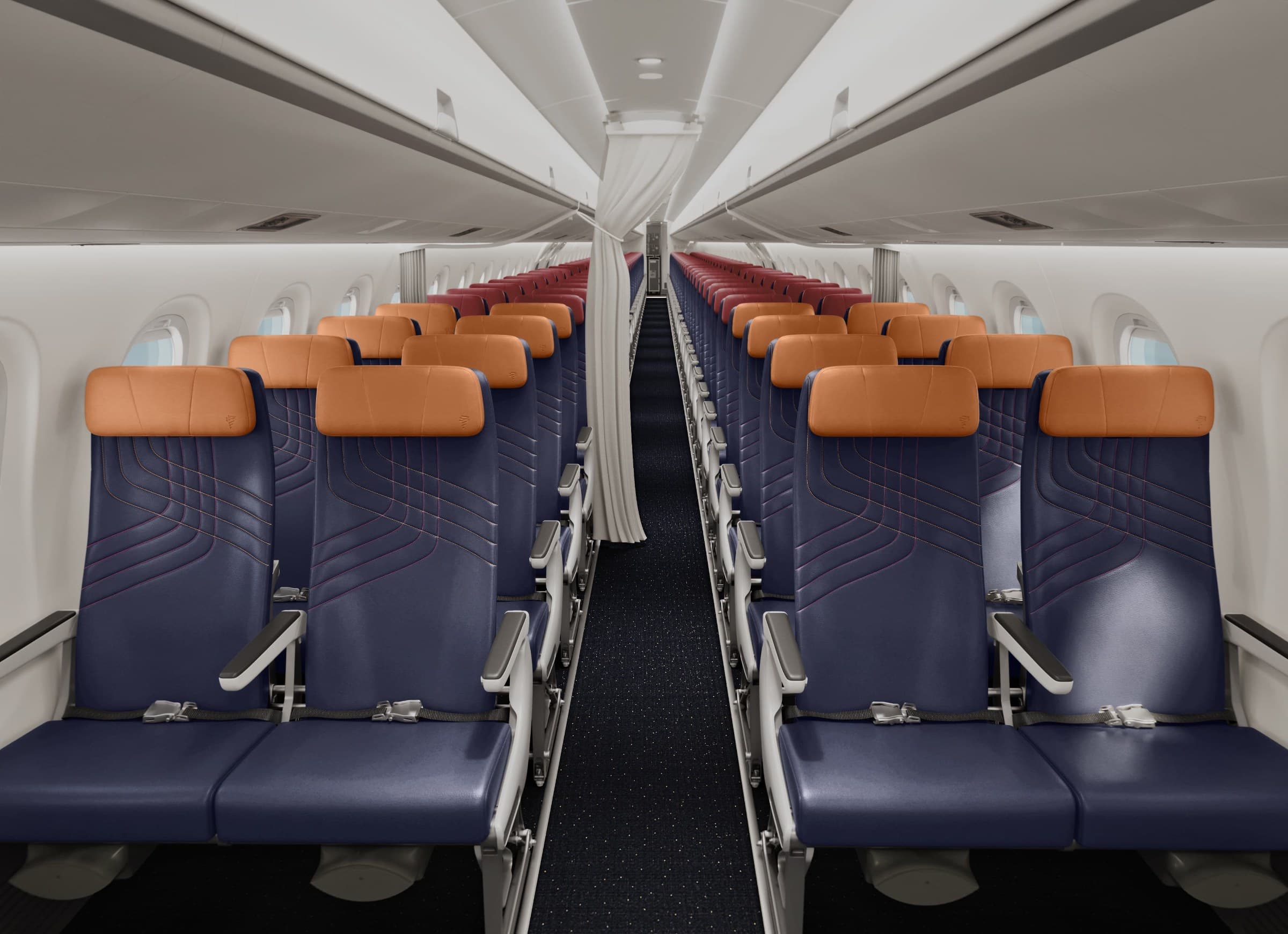 LATAM Airlines Embraer E195-E2 cabin with tan headrest covers and navy seats
