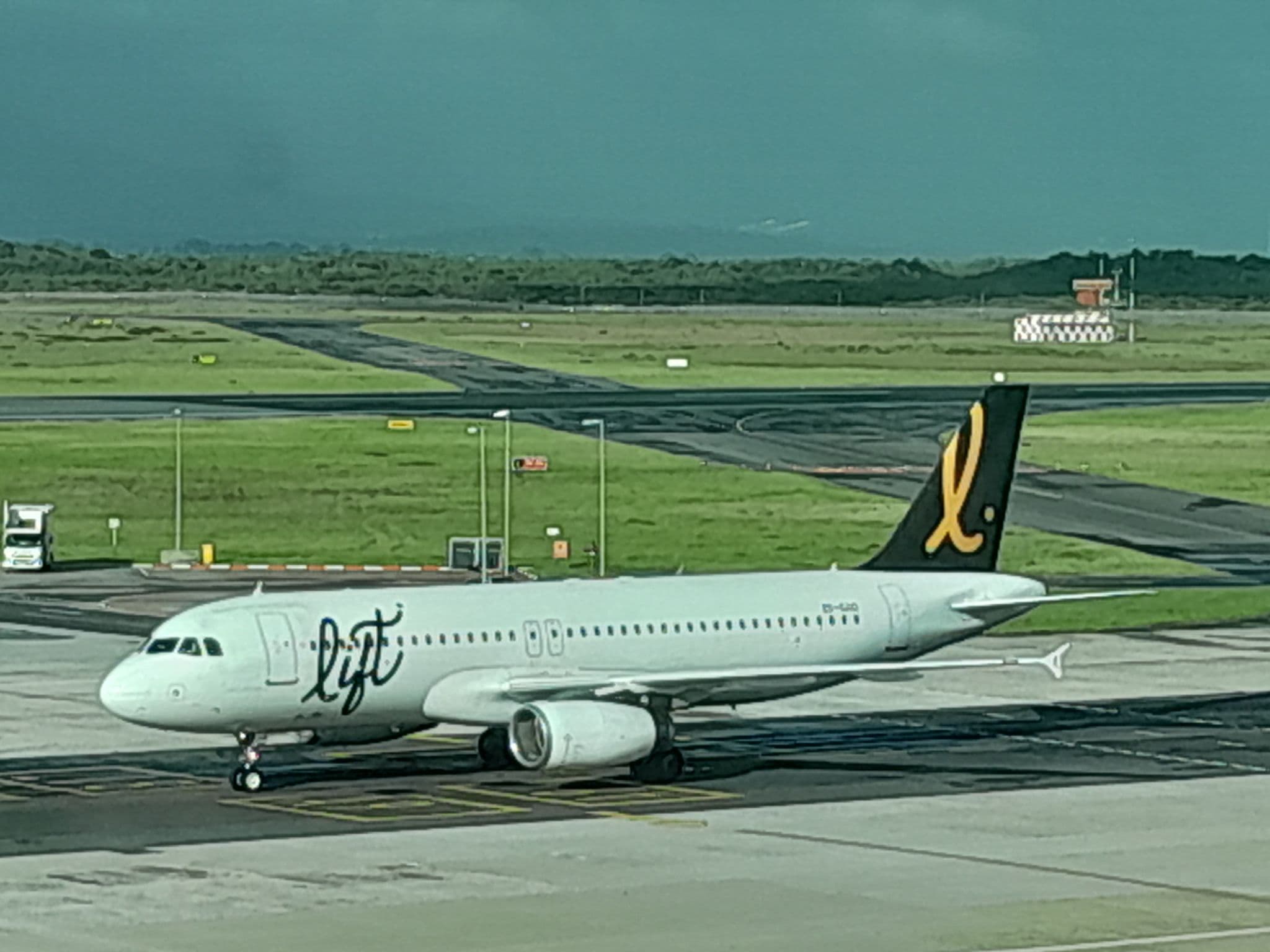 LIFT Airbus A320 ZS-GAO taxiing under a stormy sky