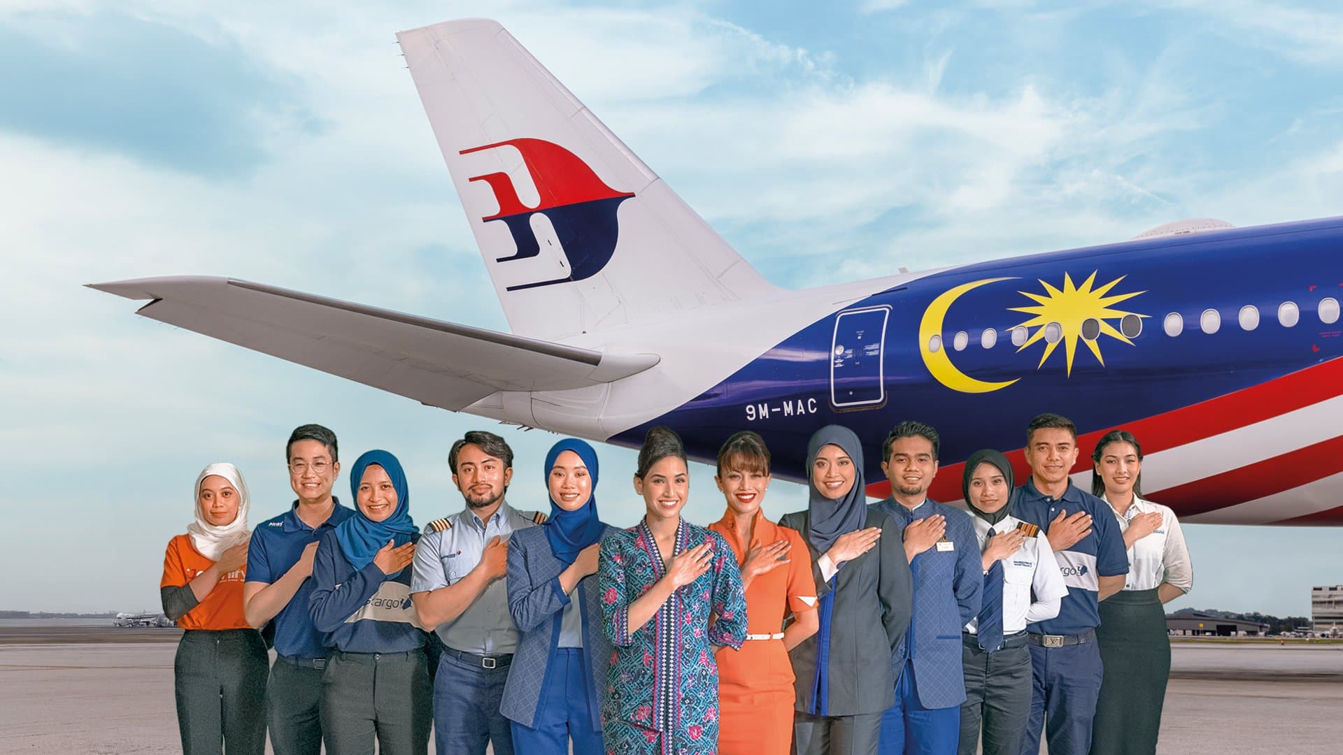 Malaysia Airlines aircraft with cabin crew standing in front of it