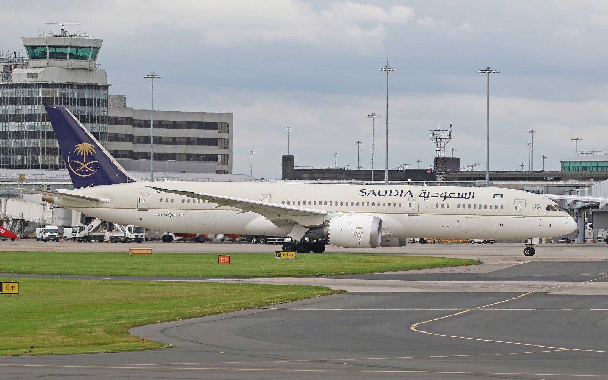 Saudia Boeing 787 Dreamliner HZ-ARB taxiing past an airport control tower