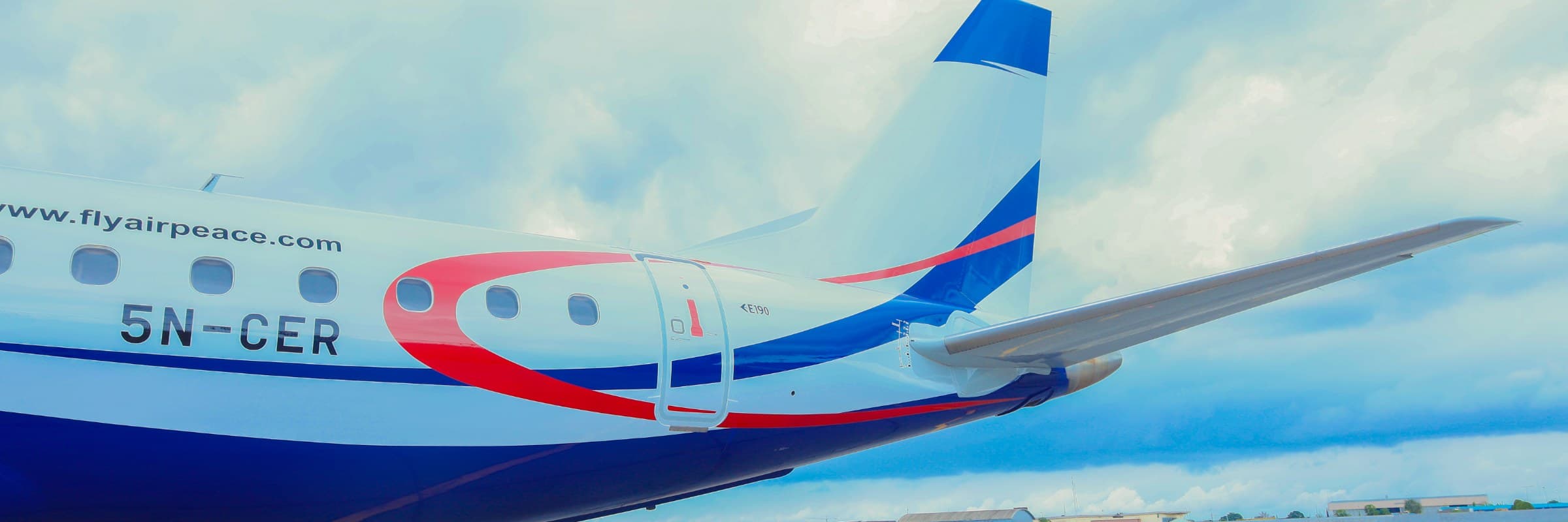 Air Peace Embraer 190 tail and livery detail on the apron