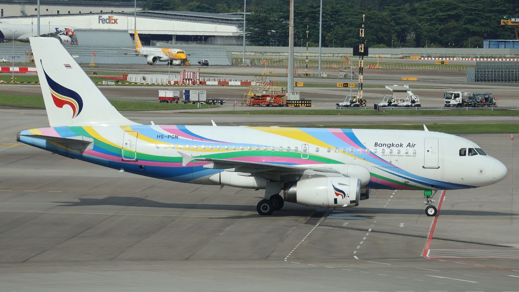Bangkok Airways Airbus A319 (HS-PGN) in multicolour livery parked at Singapore Changi Airport