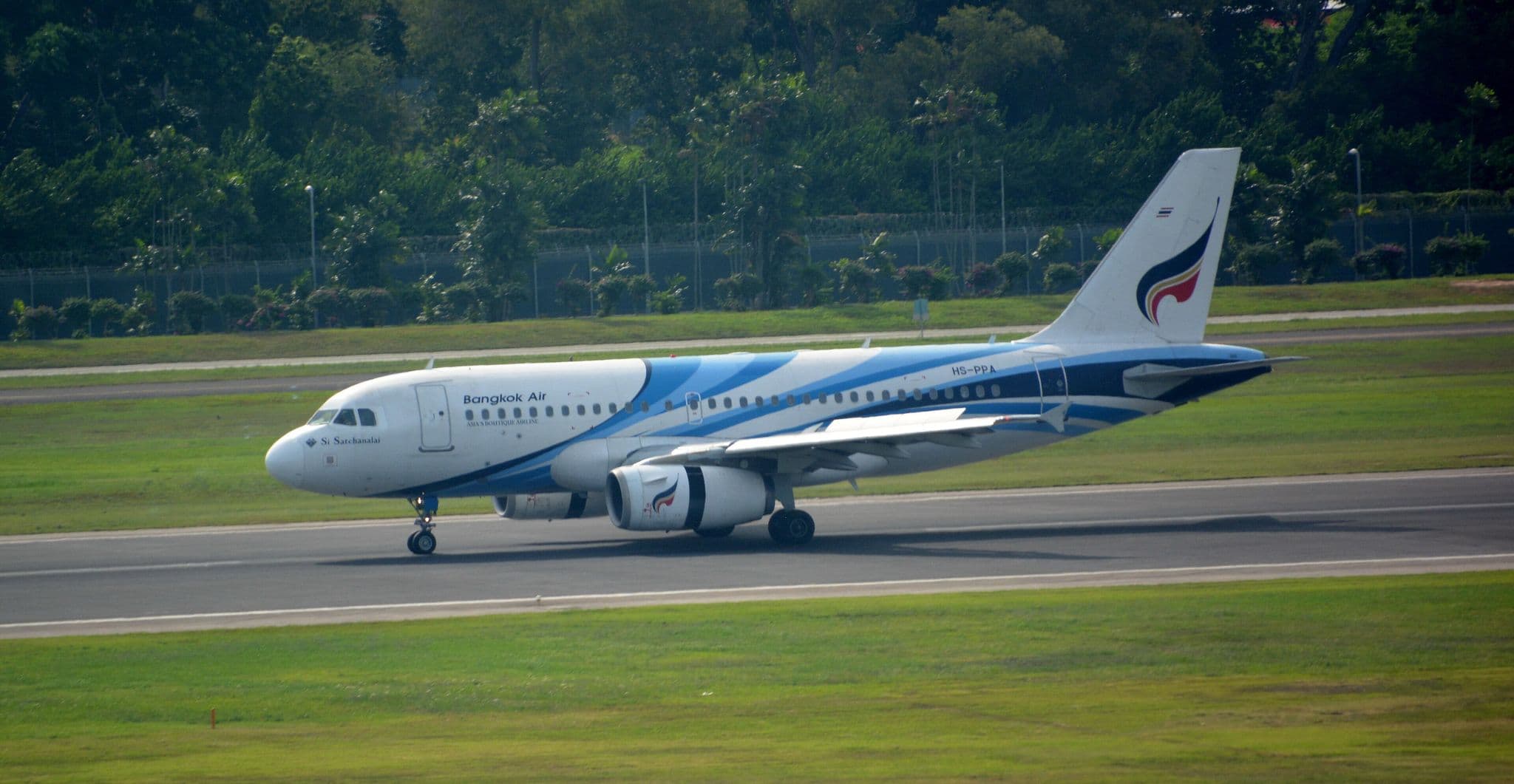 Bangkok Airways Airbus A319 (HS-PPA) in blue-and-white livery on the runway at Singapore Changi Airport