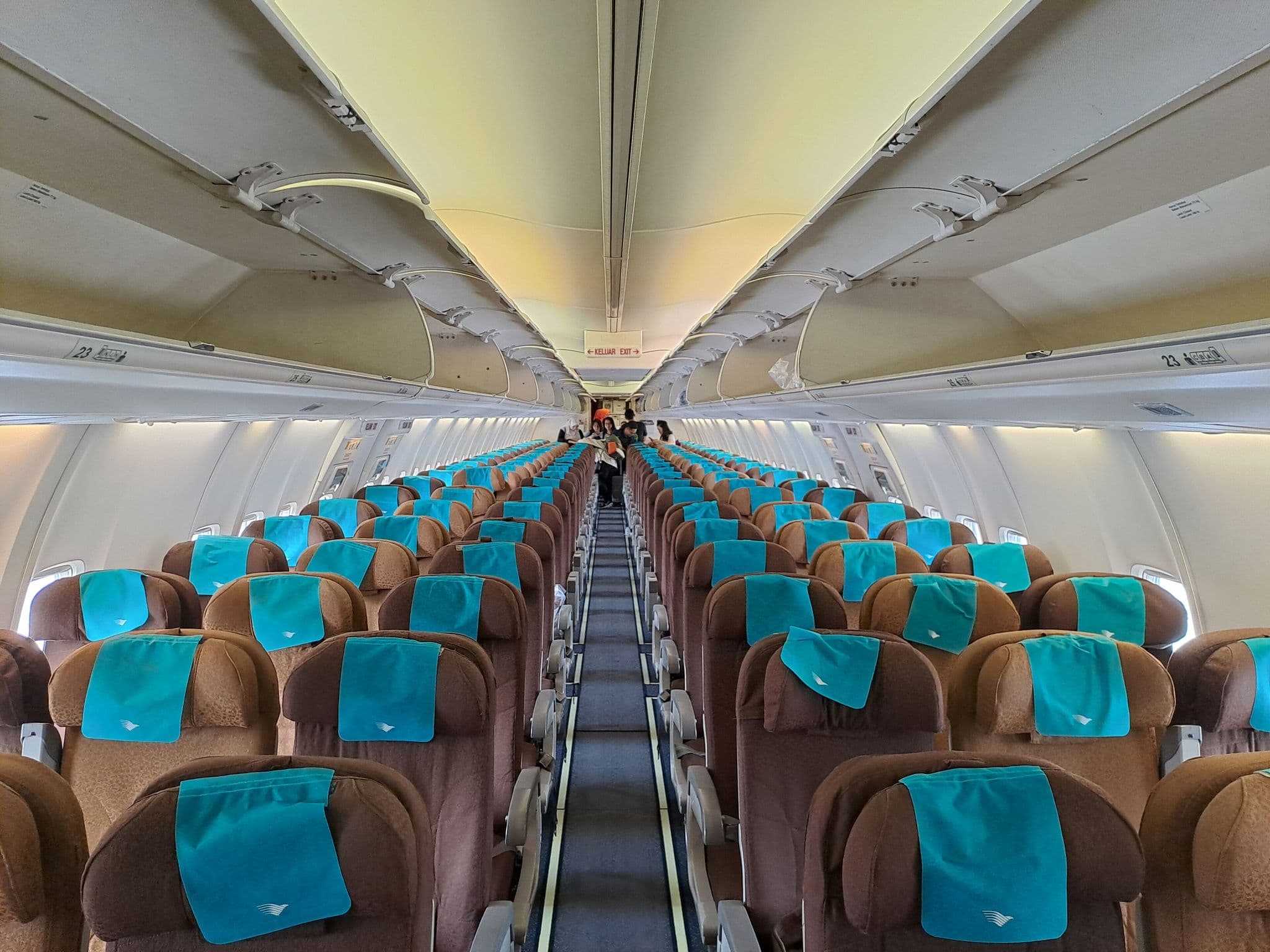 Economy cabin of a Garuda Indonesia Boeing 737-800 with teal seats