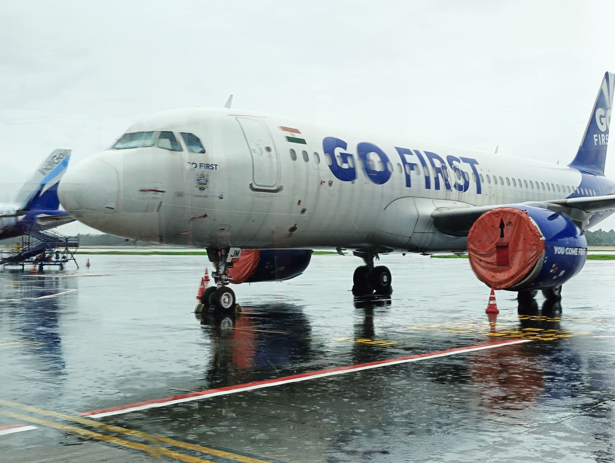 Go First Airbus A320neo parked at Kochi airport with its engines covered