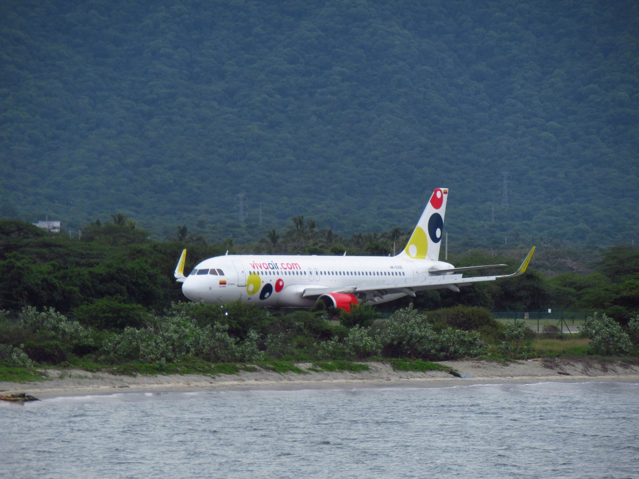 Viva Air Colombia Airbus A320 HK-5305 landing at Santa Marta Simón Bolívar International Airport by the sea